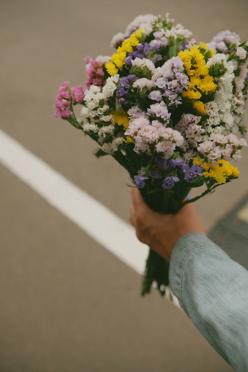 a person holding a bunch of flowers in their hand