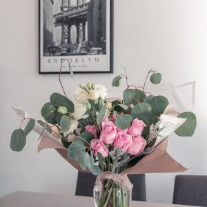 pink and white roses in clear glass vase
